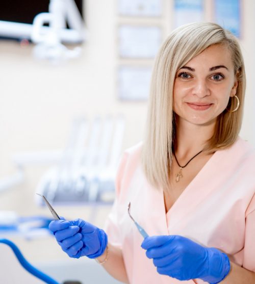 portrait-of-female-dentist-she-standing-at-her-office-and-she-has-beautiful-smile